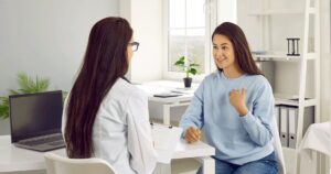 Healthcare professional providing information about the side effects of the abortion pill during a confidential consultation.