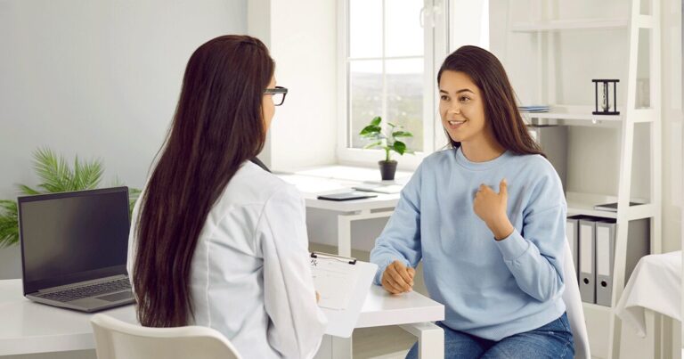 Healthcare professional providing information about the side effects of the abortion pill during a confidential consultation.