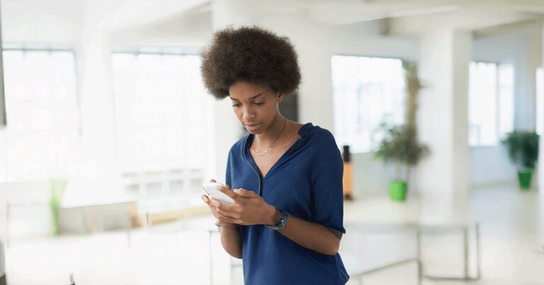 A woman uses her phone to learn about the warning signs of an incomplete abortion.